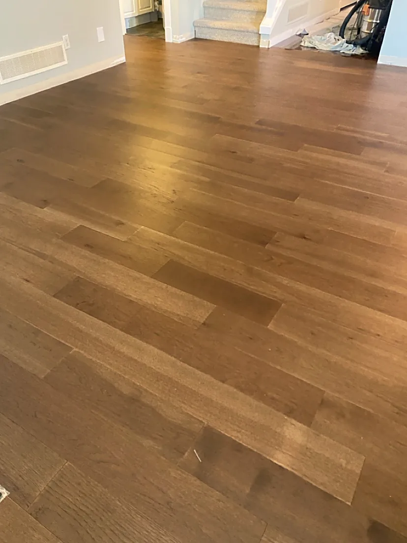 Living room with medium wood plank flooring
