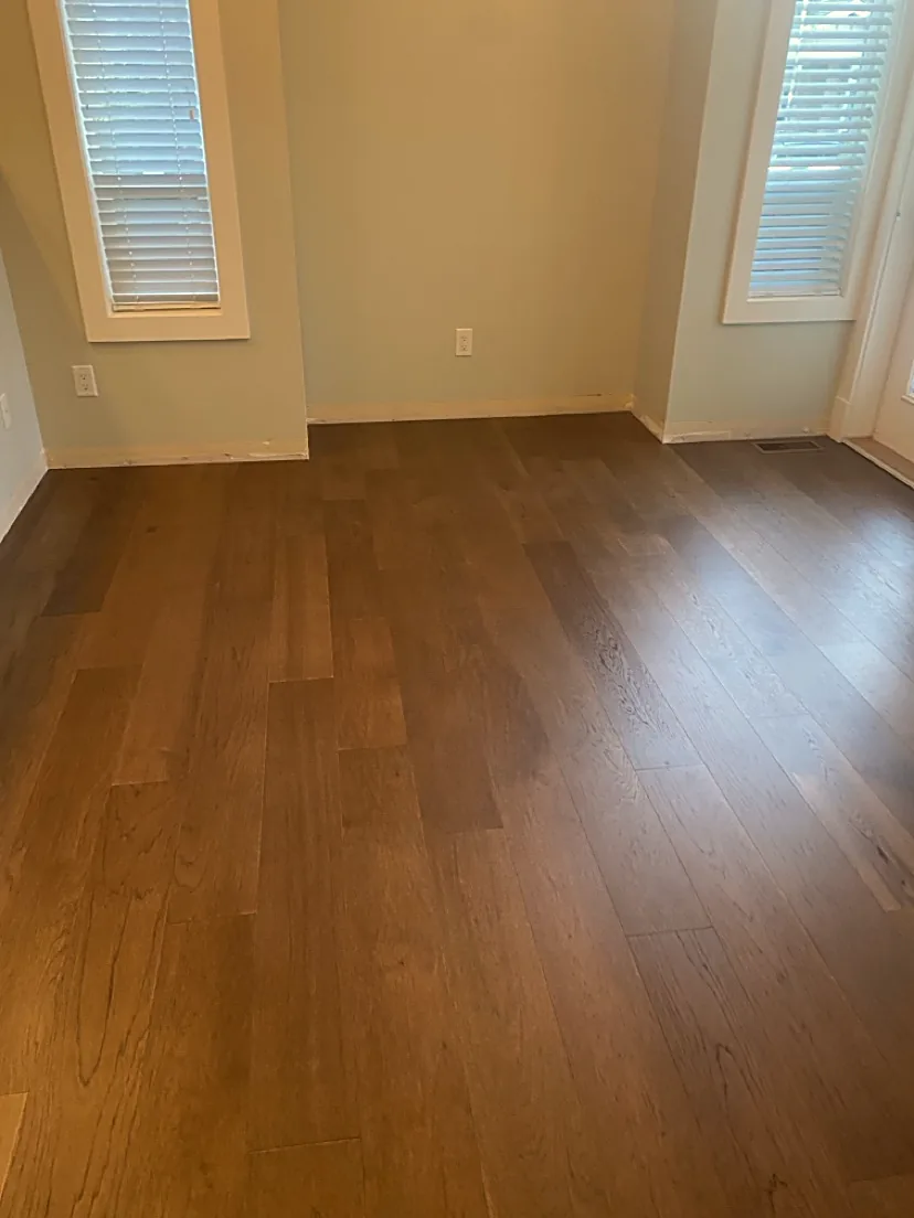 Bright room with windows and medium wood flooring